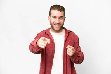 Young handsome blonde man over isolated white background surprised and pointing front