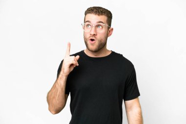 Young handsome blonde man over isolated white background thinking an idea pointing the finger up