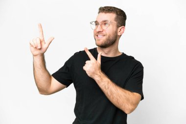 Young handsome blonde man over isolated white background pointing with the index finger a great idea