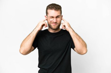 Young handsome blonde man over isolated white background frustrated and covering ears
