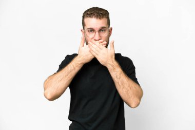 Young handsome blonde man over isolated white background covering mouth with hands