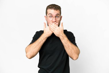 Young handsome blonde man over isolated white background covering mouth with hands