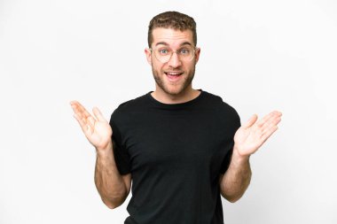 Young handsome blonde man over isolated white background with shocked facial expression