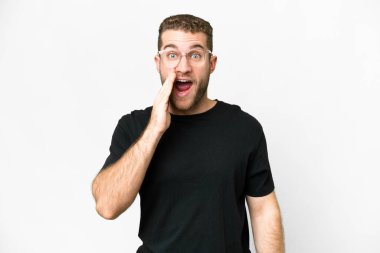 Young handsome blonde man over isolated white background with surprise and shocked facial expression