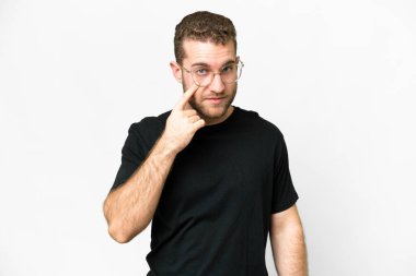 Young handsome blonde man over isolated white background showing something