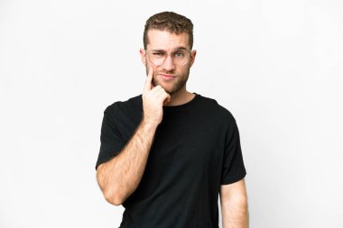 Young handsome blonde man over isolated white background and thinking