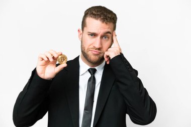 Young business blonde man holding a Bitcoin over isolated white background thinking an idea