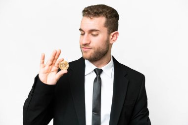 Young business blonde man holding a Bitcoin over isolated white background looking to the side