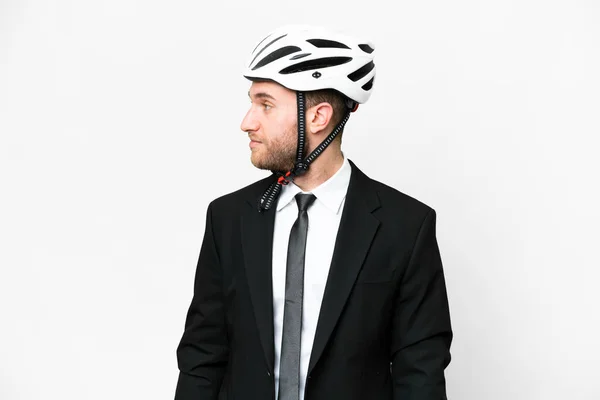 Business person with a bike helmet over isolated white background looking to the side