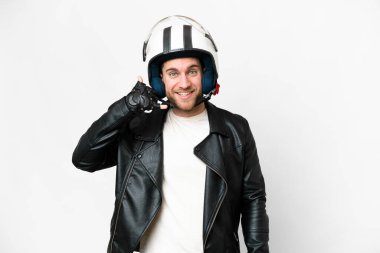 Young handsome blonde man with a motorcycle helmet over isolated white background making phone gesture. Call me back sign