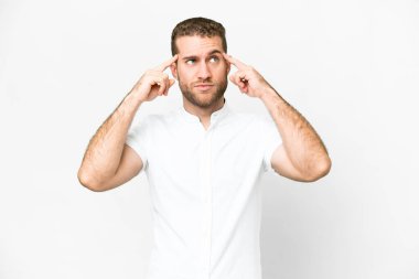 Young handsome blonde man over isolated white background having doubts and thinking