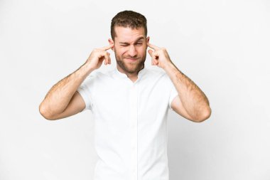 Young handsome blonde man over isolated white background frustrated and covering ears