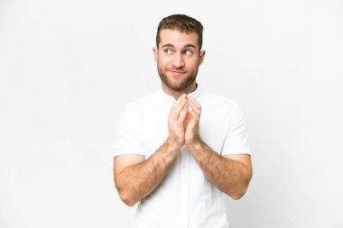 Young handsome blonde man over isolated white background scheming something