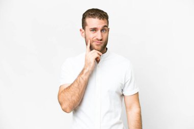 Young handsome blonde man over isolated white background and thinking