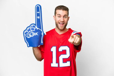 sports fan man over isolated white background surprised and pointing front