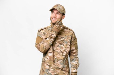 Military man over isolated white background thinking an idea while looking up