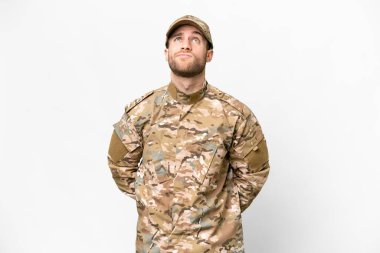 Military man over isolated white background and looking up