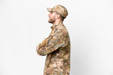 Military man over isolated white background in lateral position