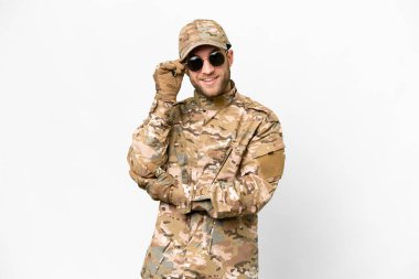Military man over isolated white background with glasses and happy