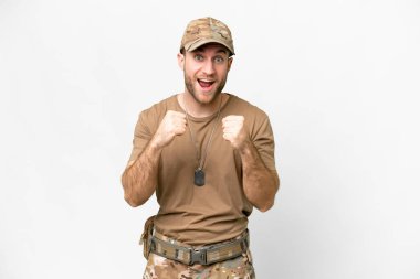 Military with dog tag over isolated white background celebrating a victory in winner position
