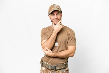 Military with dog tag over isolated white background smiling
