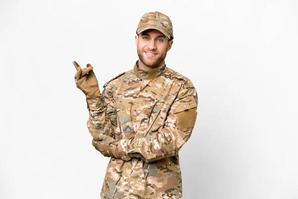 Military man over isolated white background pointing finger to the side