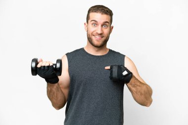 Young sport man making weightlifting over isolated white background with surprise facial expression