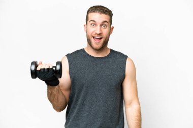 Young sport man making weightlifting over isolated white background with surprise and shocked facial expression