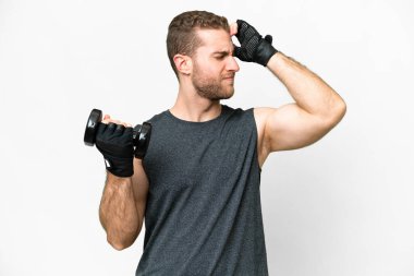 Young sport man making weightlifting over isolated white background having doubts and with confuse face expression