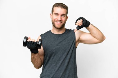 Young sport man making weightlifting over isolated white background proud and self-satisfied