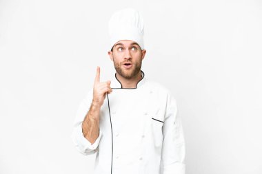Young blonde man Chef over isolated white background thinking an idea pointing the finger up