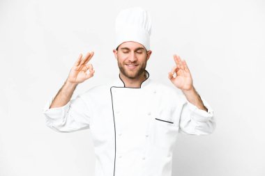 Young blonde man Chef over isolated white background in zen pose