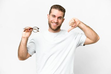 Young handsome blonde man with glasses over isolated white background proud and self-satisfied