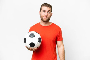 Handsome young football player man over isolated white background and looking up