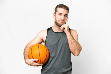 Handsome young man playing basketball over isolated white background thinking an idea