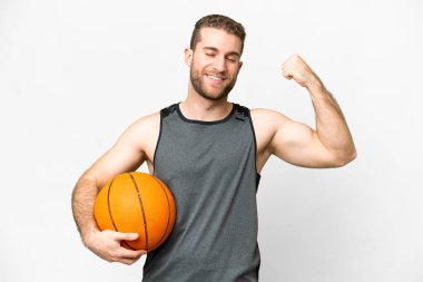 Handsome young man playing basketball over isolated white background doing strong gesture