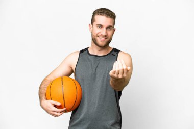 Handsome young man playing basketball over isolated white background inviting to come with hand. Happy that you came