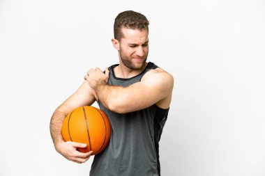 Handsome young man playing basketball over isolated white background suffering from pain in shoulder for having made an effort