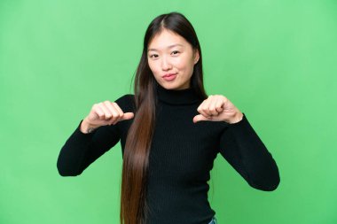 Young Asian woman over isolated chroma key background proud and self-satisfied