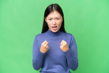 Young Asian woman over isolated chroma key background frustrated by a bad situation