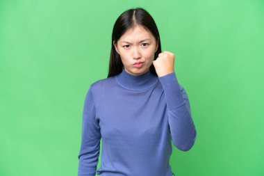Young Asian woman over isolated chroma key background with unhappy expression