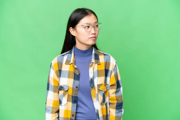 Young Asian Woman Isolated Chroma Key Background Looking Side — Stockfoto