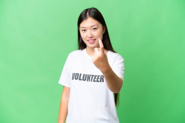 Young volunteer woman over isolated chroma key background doing coming gesture