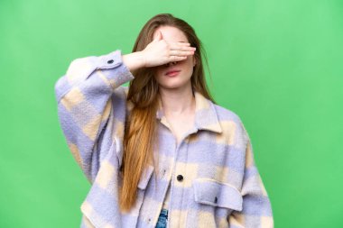 Young pretty woman over isolated chroma key background covering eyes by hands. Do not want to see something