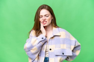 Young pretty woman over isolated chroma key background with toothache