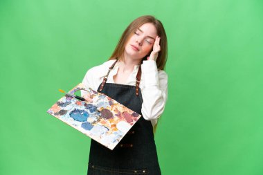 Young artist woman holding a palette over isolated chroma key background with headache