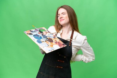 Young artist woman holding a palette over isolated chroma key background suffering from backache for having made an effort