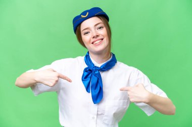 Airplane stewardess over isolated chroma key background proud and self-satisfied