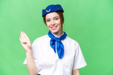 Airplane stewardess over isolated chroma key background happy and counting four with fingers