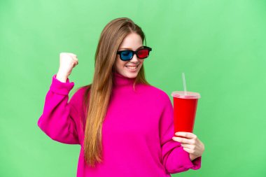 Young woman holding soda while watching a 3D movie celebrating a victory